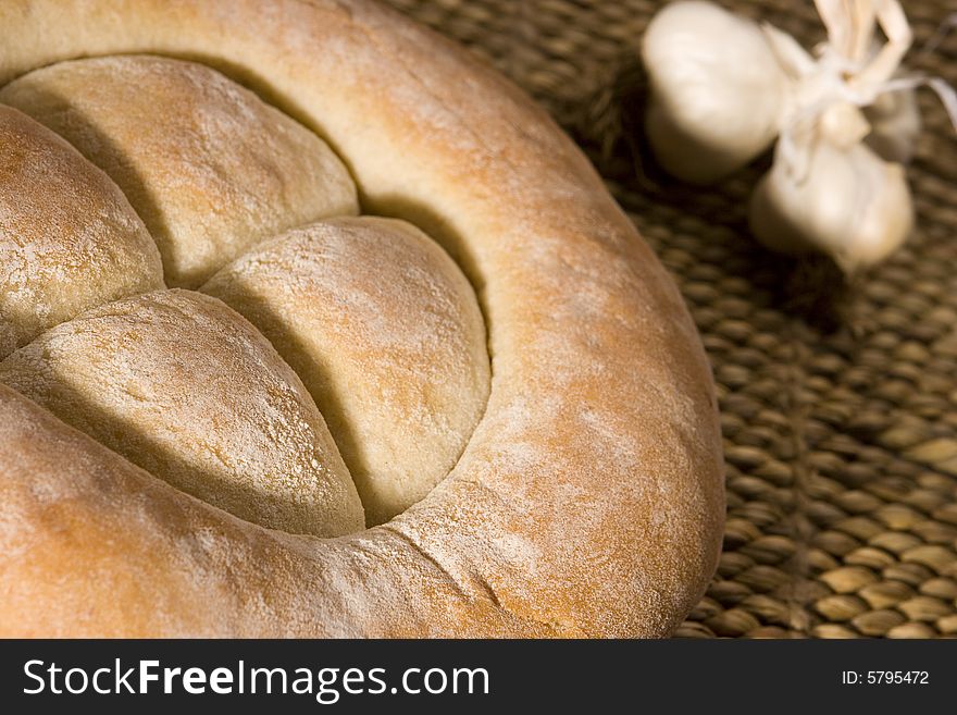 Made in the studio, bread on wood isolated on white; healthy food; garlic on background. Made in the studio, bread on wood isolated on white; healthy food; garlic on background