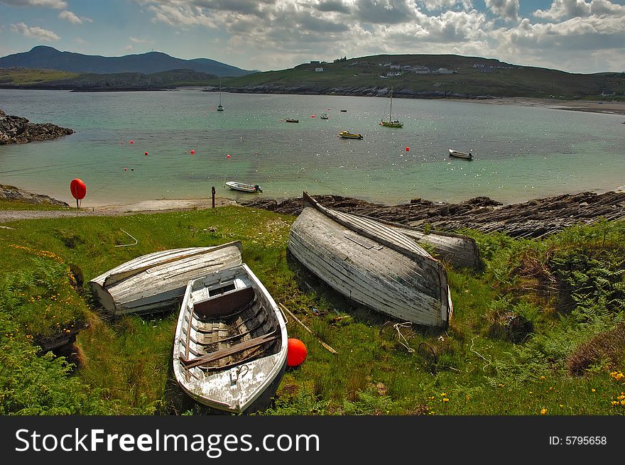 Boats on bank with sea in background