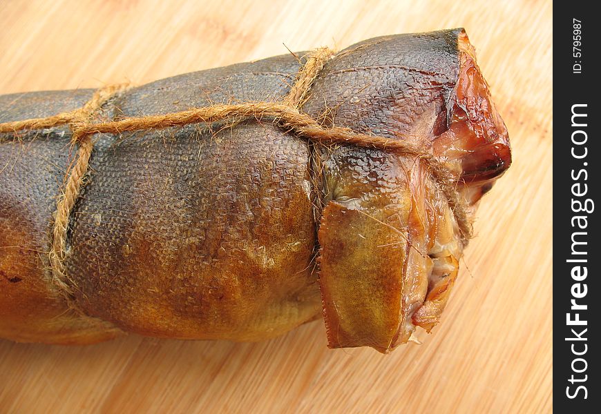 A hot smoked fish on the wooden board