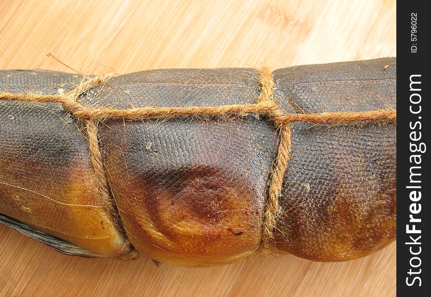 A hot smoked fish on the wooden board
