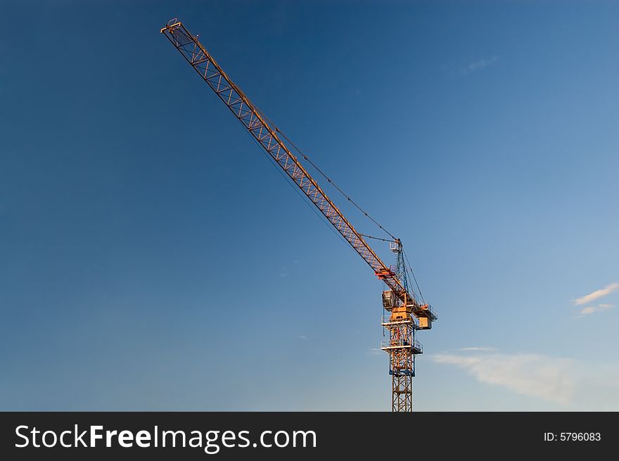 Elevating crane on sky background