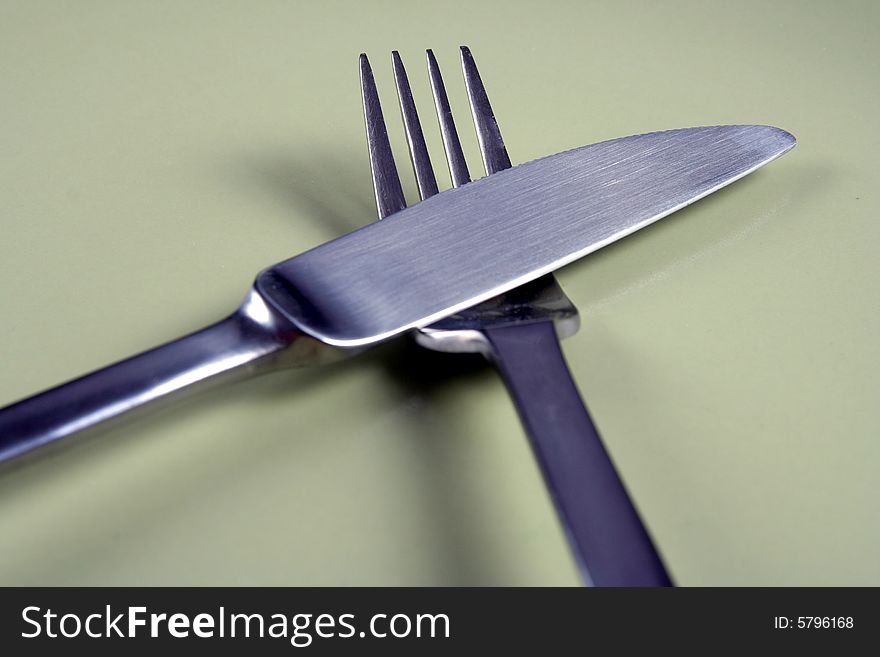 Fork  and  knife  on  green  plate