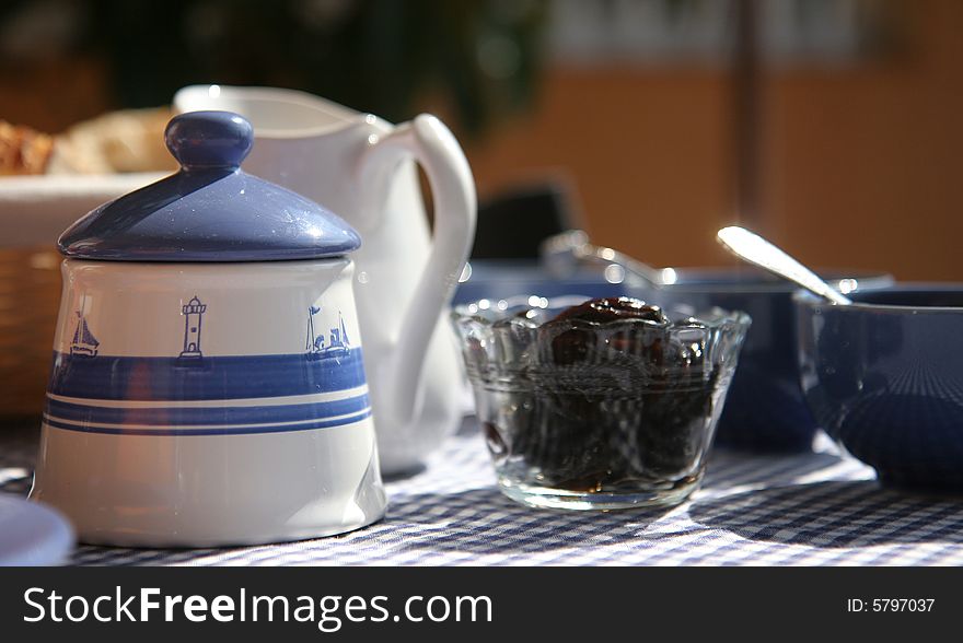 Breakfast table on sunny terrace, French Riviera, with bowls