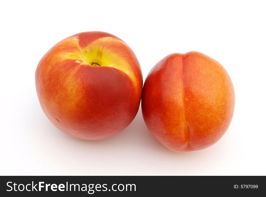 A photograph of nectarines against a white background