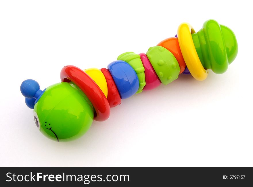 A photograph of a toy catapillar against a white background
