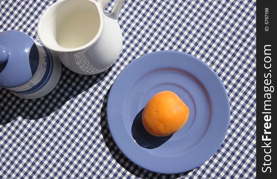 Breakfast table on sunny terrace, French Riviera, with apricot