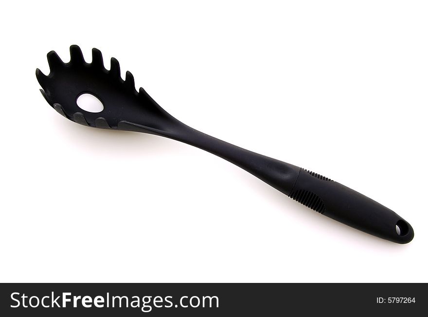 A photograph of a pasta scoop against a white background