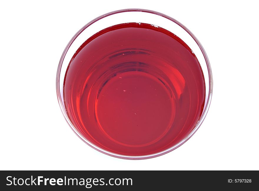 A photograph of cranberry juice in a glass against a white background