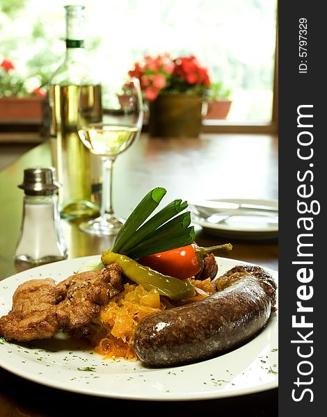 Traditional Slovak sausage with vegetables, white wine in Traditional Slovak Restaurant. Traditional Slovak sausage with vegetables, white wine in Traditional Slovak Restaurant