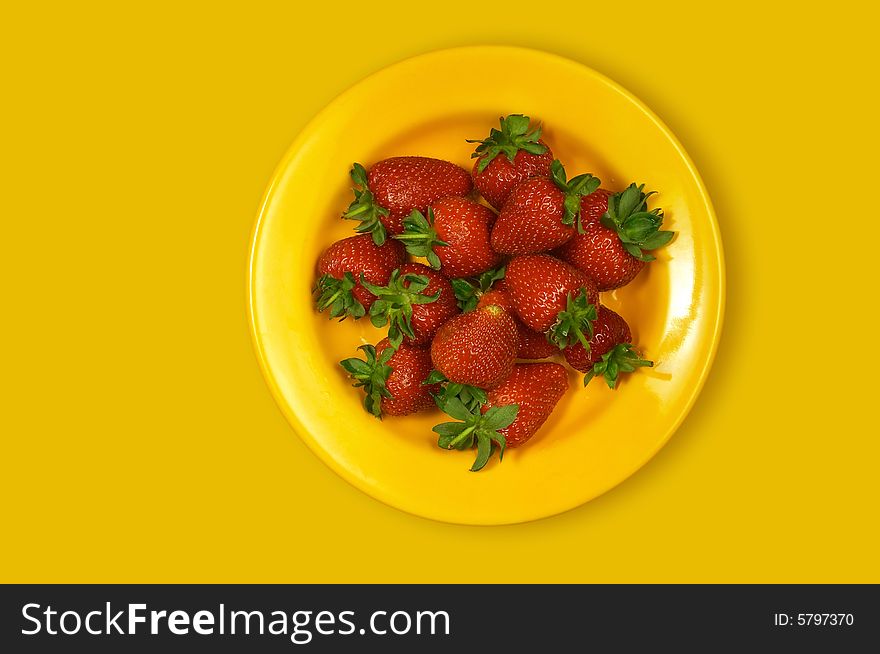 Sweet strawberries on yellow plate. Sweet strawberries on yellow plate