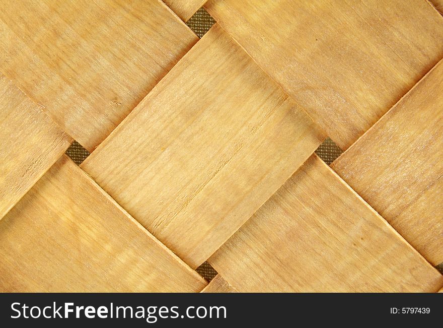 A photograph of a wood basket against a white background