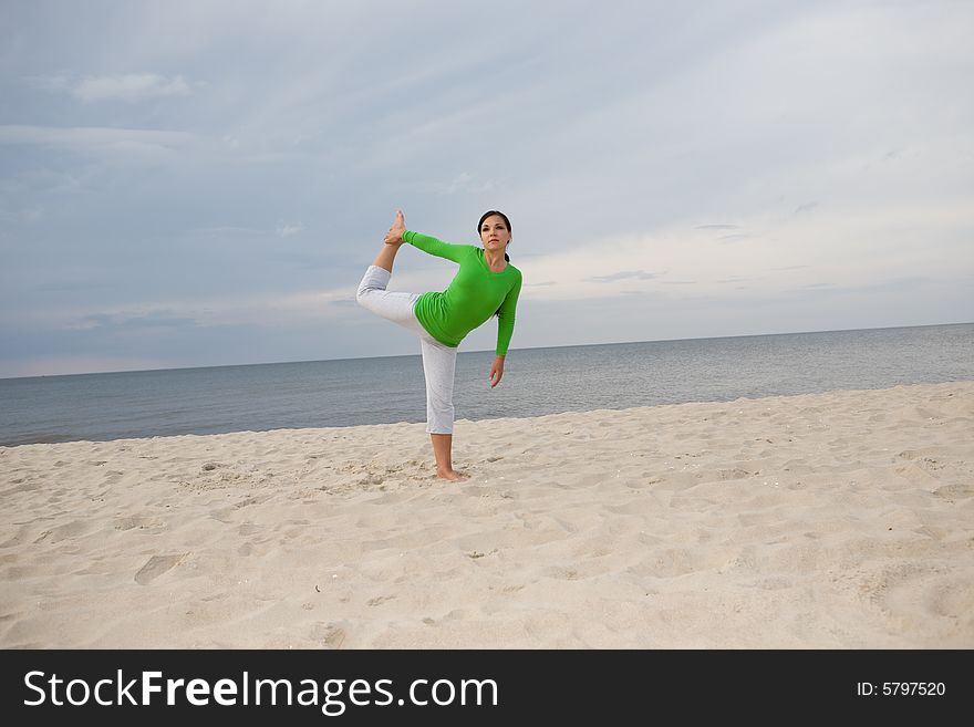 Active woman doing exercise on the beach