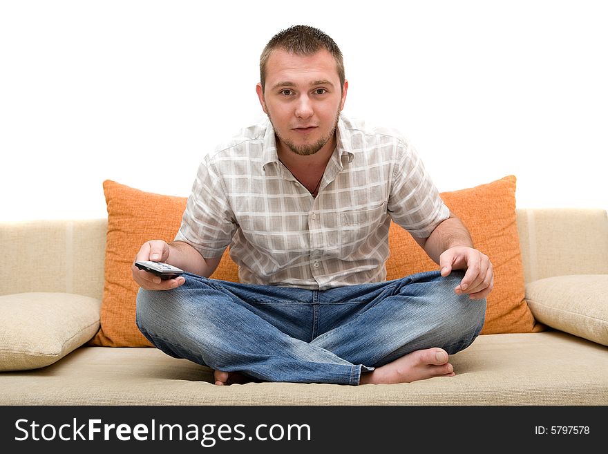 Casualman sitting on sofa with remote control. Casualman sitting on sofa with remote control