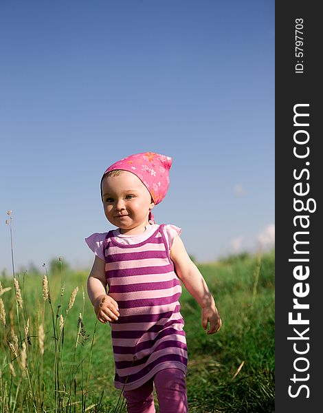 Happy baby girl on green meadow. Happy baby girl on green meadow