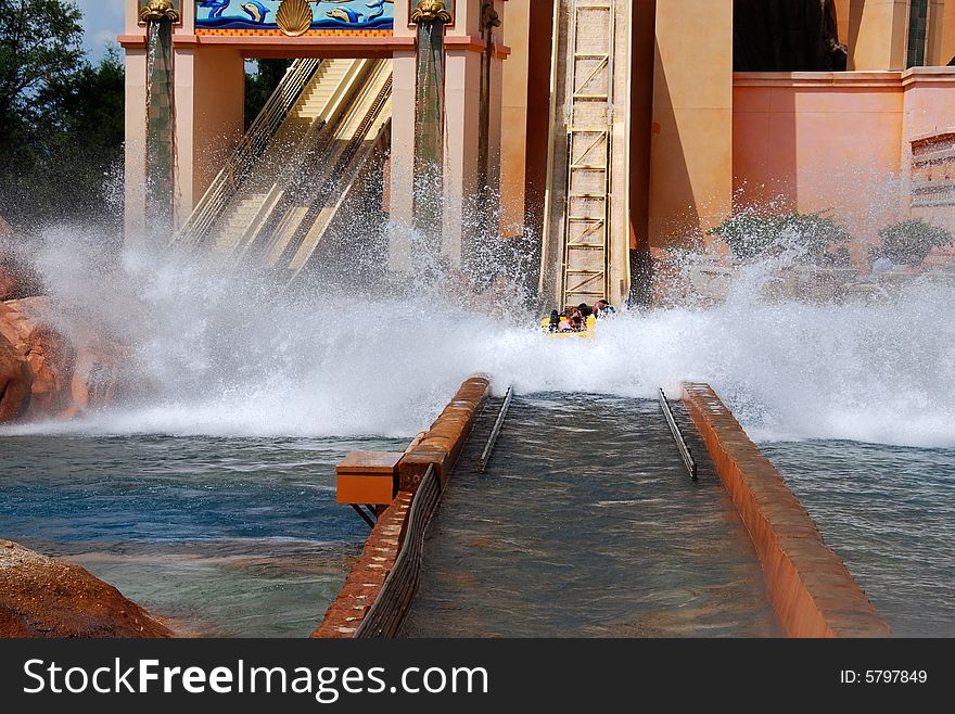 People fall into water during a ride in a water park. People fall into water during a ride in a water park