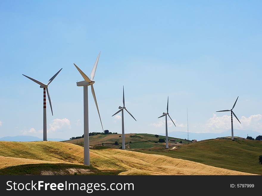 Windmills on a hill in summer day