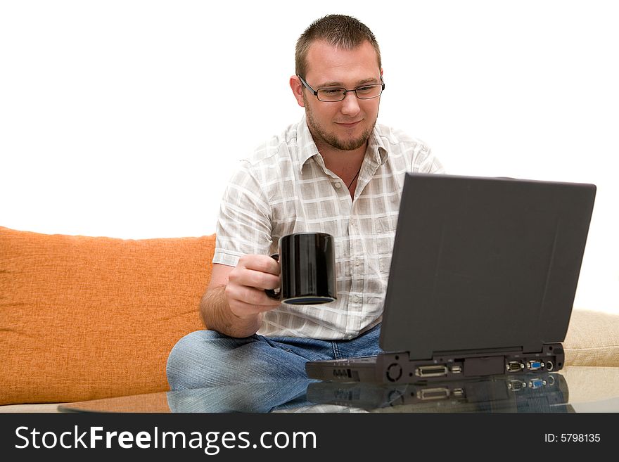 Happy man sitting on sofa with laptop. Happy man sitting on sofa with laptop