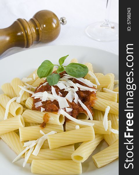 A rigatoni dish with tomato sauce, goat cheese and basil. Focus on the pasta. A rigatoni dish with tomato sauce, goat cheese and basil. Focus on the pasta.