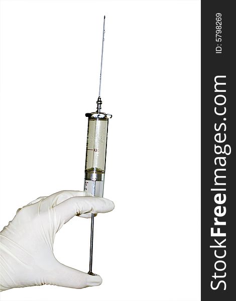 Close look of  a hand in glove holding the syringe isolated on the white background. Close look of  a hand in glove holding the syringe isolated on the white background