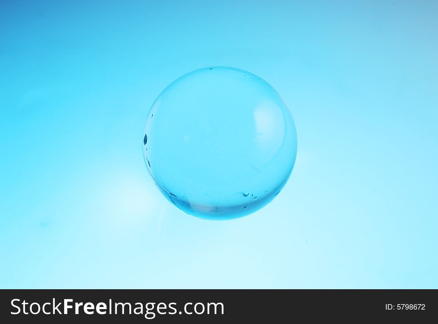 Crystal ball bathed in blue and turquoise light. Crystal ball bathed in blue and turquoise light