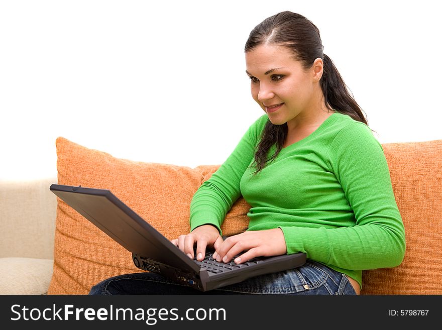 Attractive brunette woman on sofa with laptop. Attractive brunette woman on sofa with laptop