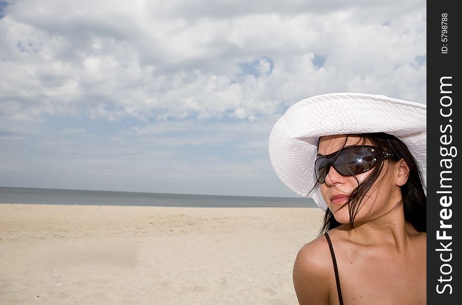 Attractive brunette woman relaxing on beach. Attractive brunette woman relaxing on beach