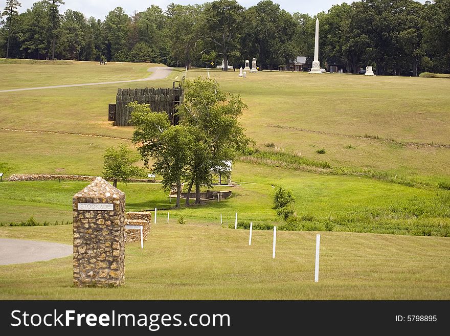 The stone marker stands at the S.W. conner of the Andersonville Stockade prison and the line of white posts to the right mark the position of the dead line. The stone marker stands at the S.W. conner of the Andersonville Stockade prison and the line of white posts to the right mark the position of the dead line