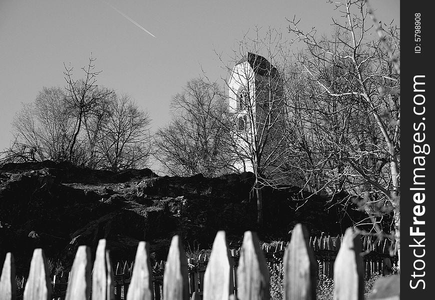 A suggestive monochrome of a fench with a chuch in the background. A suggestive monochrome of a fench with a chuch in the background