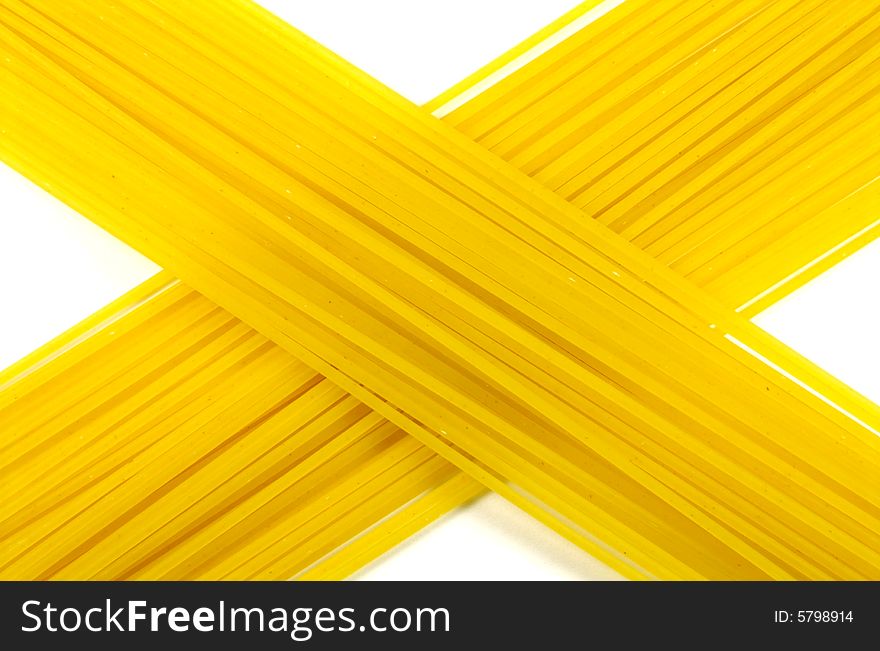 A photograph of dried spaghetti against a white background. A photograph of dried spaghetti against a white background