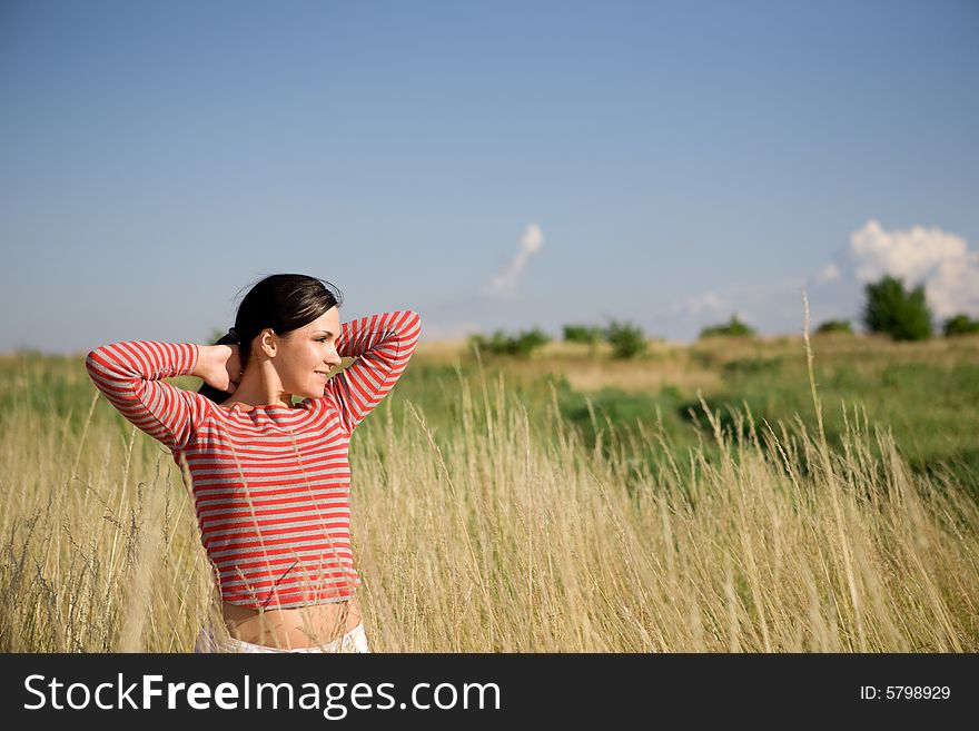 Attractive brunette woman relaxing on meadow. Attractive brunette woman relaxing on meadow