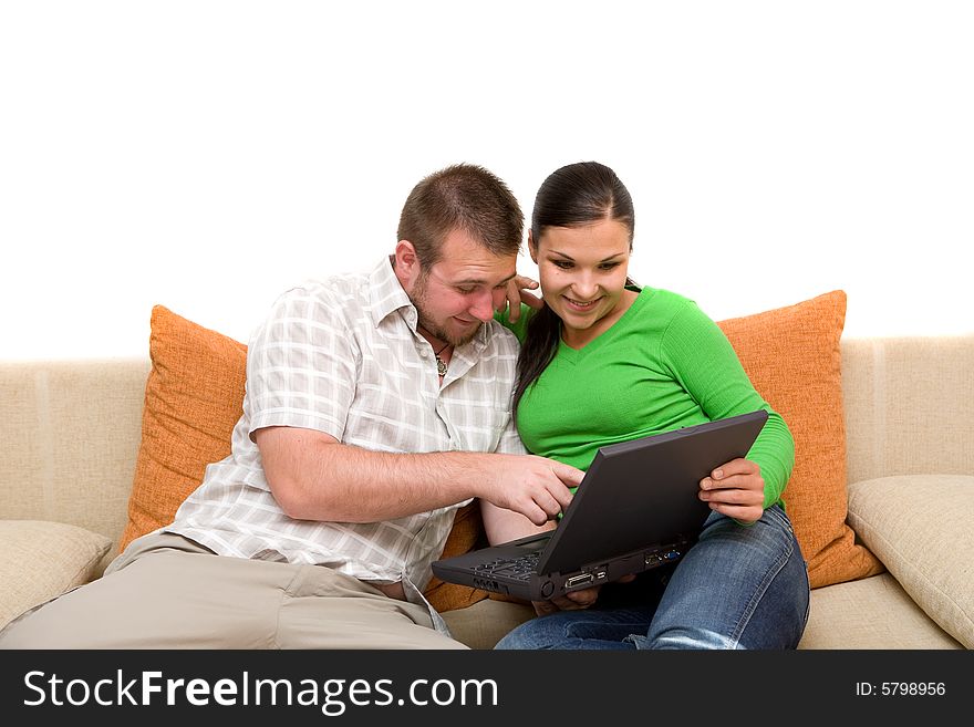 Happy couple sitting on sofa with laptop. Happy couple sitting on sofa with laptop