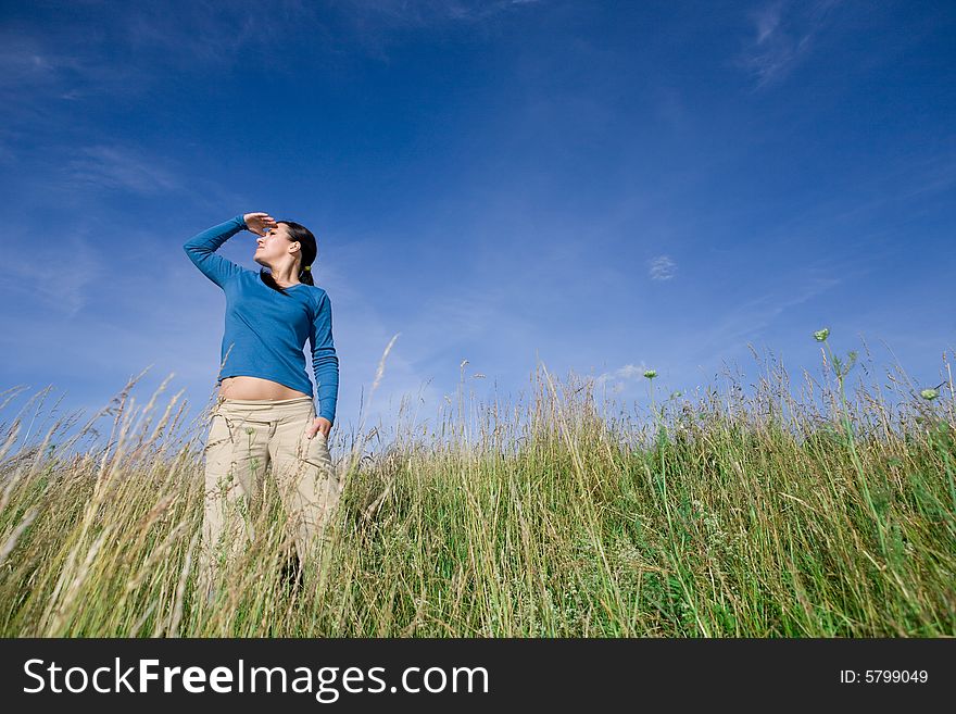 Attractive brunette woman relaxing on meadow. Attractive brunette woman relaxing on meadow