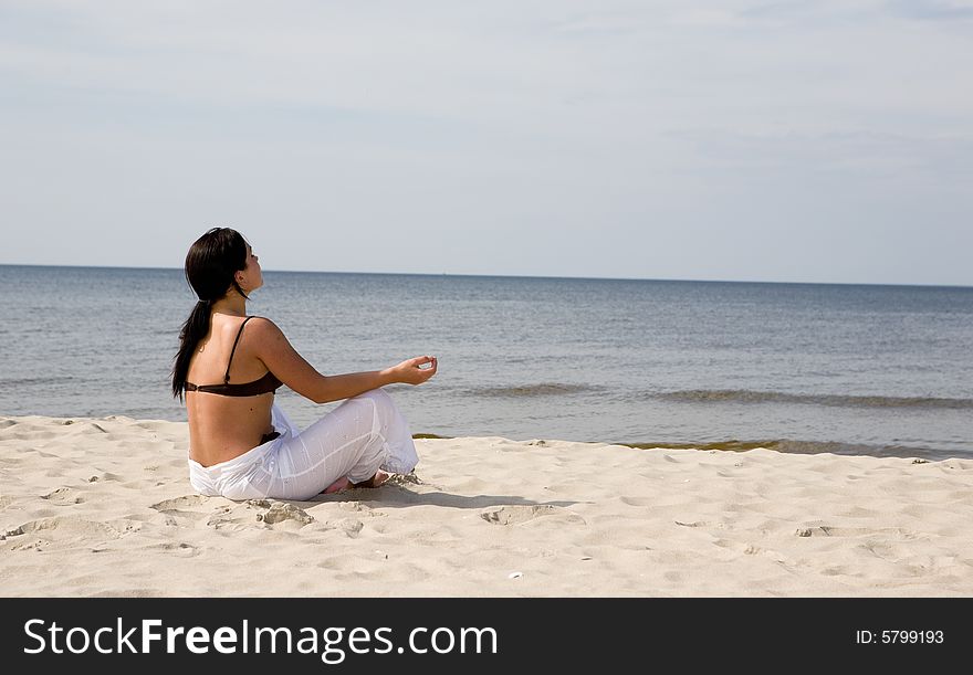 Active woman doing exercise on the beach
