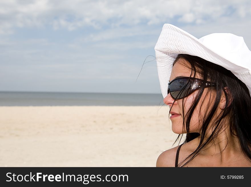 Attractive brunette woman relaxing on beach. Attractive brunette woman relaxing on beach