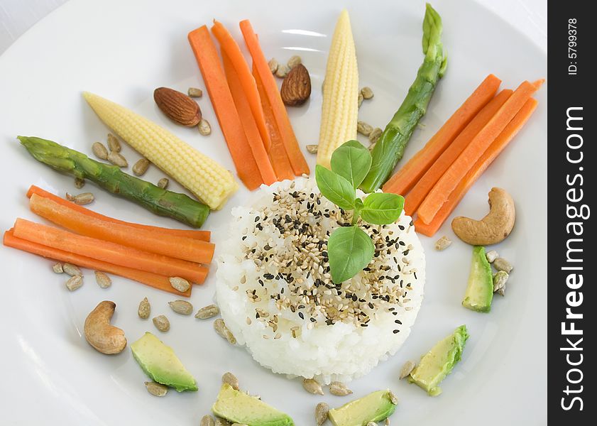 Glutinous rice and sesame seeds with carrots, baby corn, asparagus, avocado, sunflower seeds, almonds and cashew nuts. Focus on the rice. Glutinous rice and sesame seeds with carrots, baby corn, asparagus, avocado, sunflower seeds, almonds and cashew nuts. Focus on the rice.
