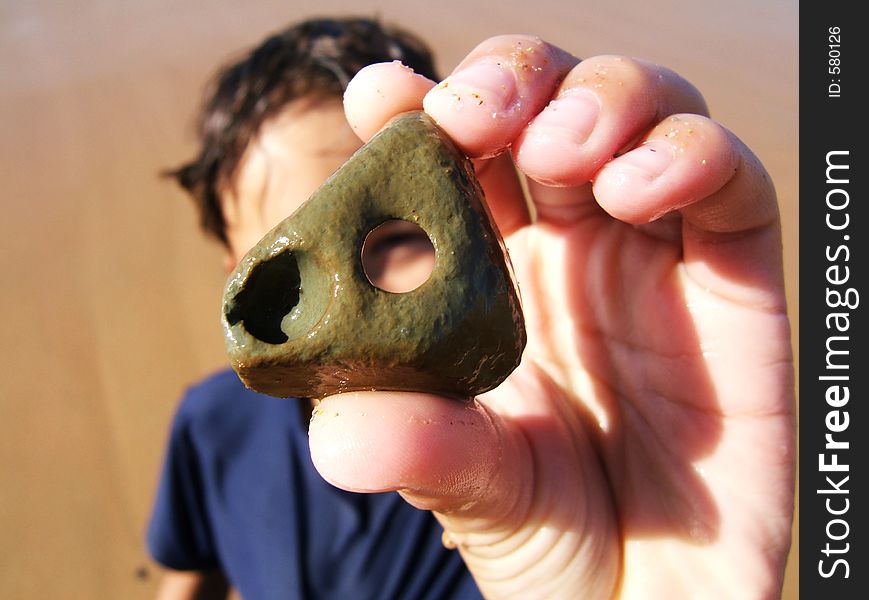 Boy looking through a whole in a rock. Boy looking through a whole in a rock