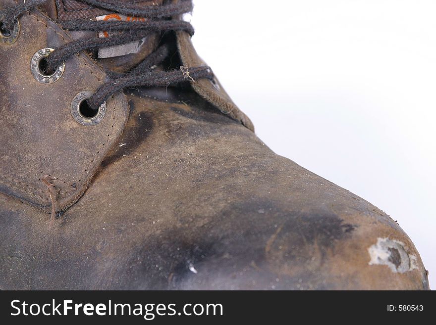 A well worn close up of a work boot. A well worn close up of a work boot.