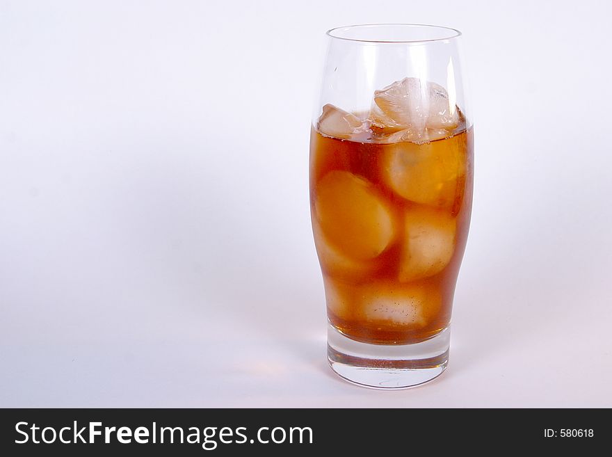 An isolated view of a glass of ice tea on ice. An isolated view of a glass of ice tea on ice.