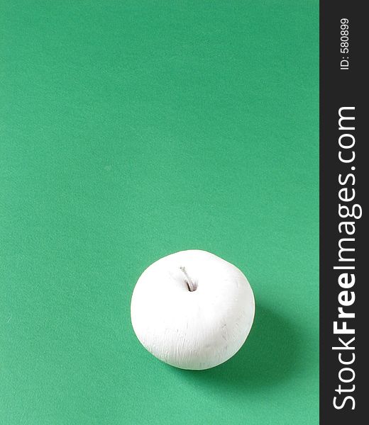 White apple isolated on green background