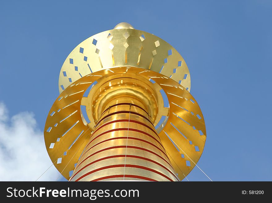 Decorative gold top on a mosque against a blue sky