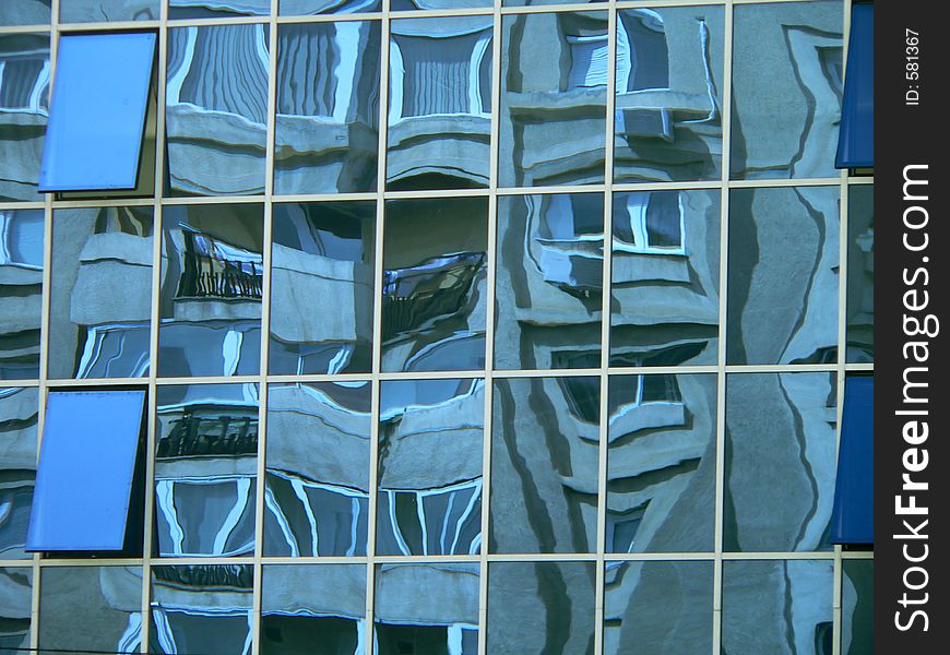 The reflection af a concret buil;ding in a glass building. The reflection af a concret buil;ding in a glass building