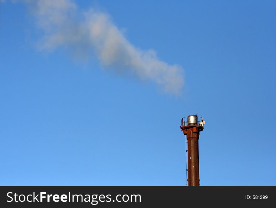 Industrial chimney against a blue sky