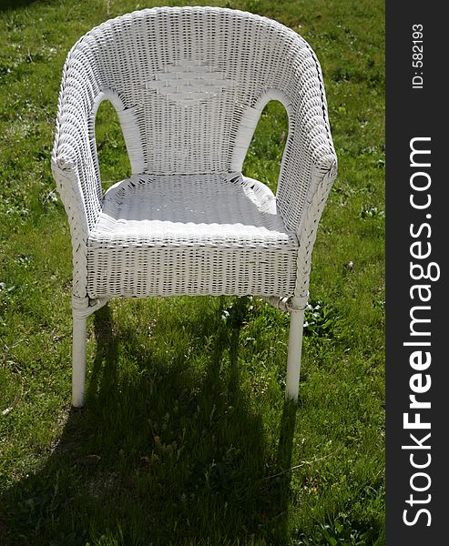 White garden chair in a grass floor