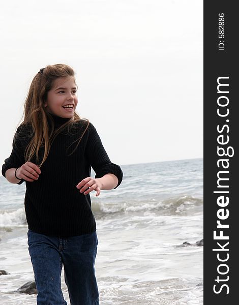 Young girl with Pacific Ocean in the background. Young girl with Pacific Ocean in the background