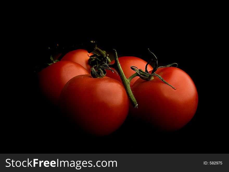 Tomatoes on dark background