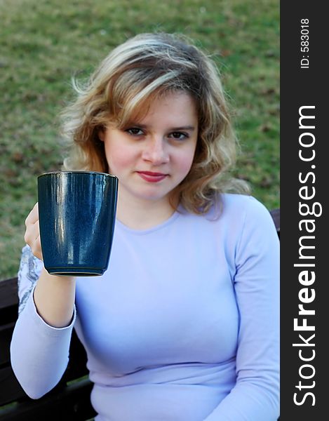 Attractive girl holds a mug. Attractive girl holds a mug