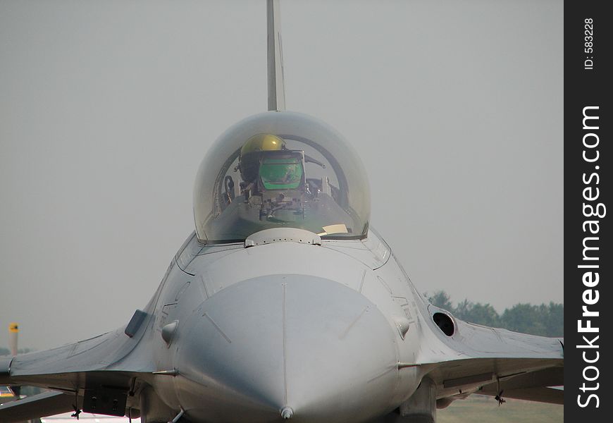 Pilot inside the cockpit of a fighter jet.