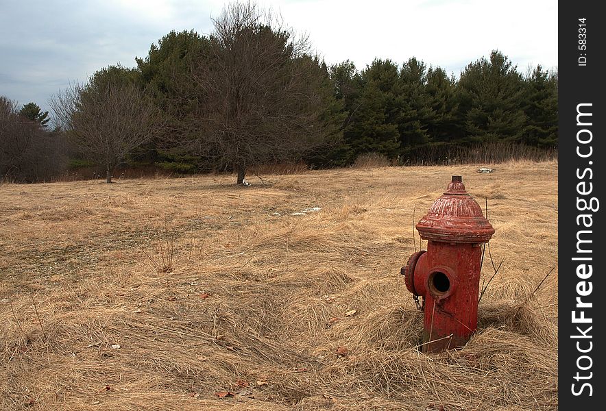 Old Red fire-hydrant in field. Old Red fire-hydrant in field