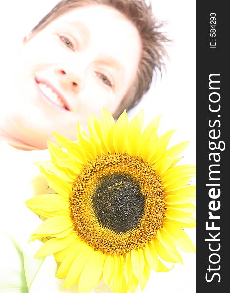 Close up of a woman's face and a sunflower. Close up of a woman's face and a sunflower