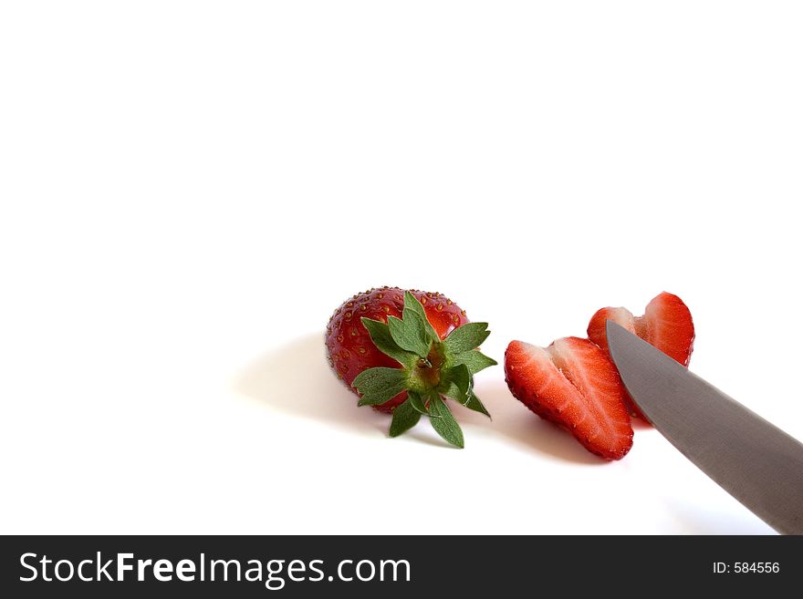 Strawberries with knife in white background